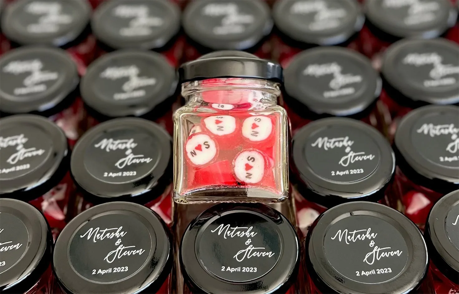Personalised wedding rock candy in a glass jar as a wedding favour
